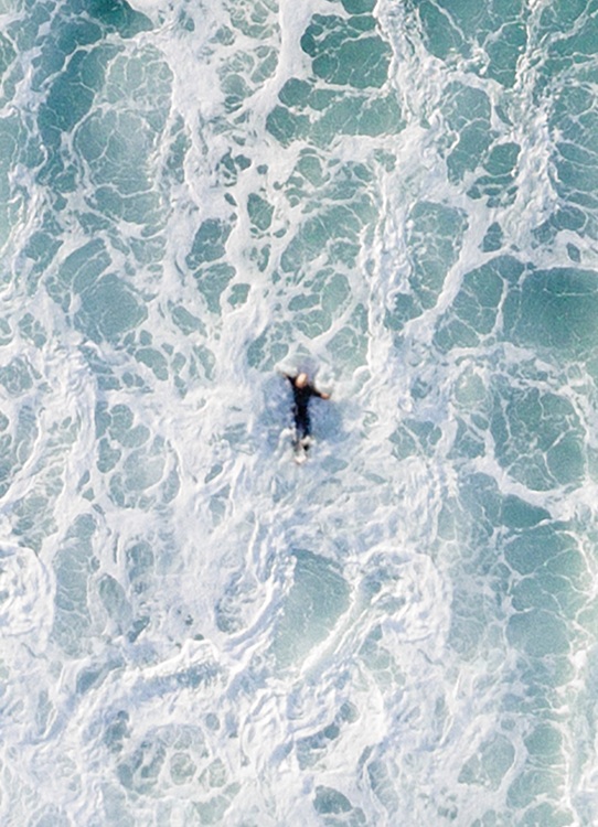 –Photo vue d’en haut d’un océan avec une grosse vague se dirigeant vers un surfeur